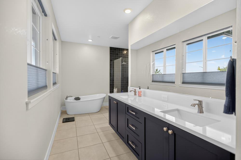12086 Mircado Way Rancho Cordova, CA 95742 - Photo 51 of 84 a spacious bathroom with a double vanity sink toilet mirror and bathtub