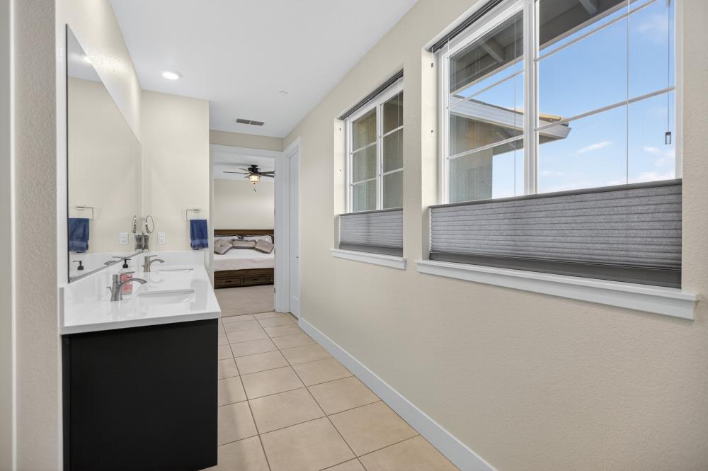 12086 Mircado Way Rancho Cordova, CA 95742 - Photo 54 of 84 a en suite bathroom with a sink and mirror