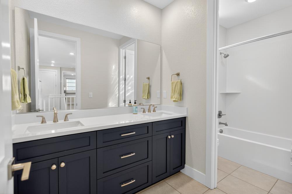 12086 Mircado Way Rancho Cordova, CA 95742 - Photo 60 of 84 a bathroom with a granite countertop sink mirror and double
