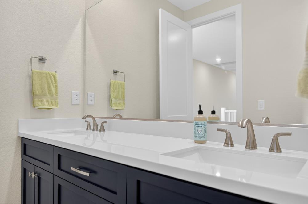12086 Mircado Way Rancho Cordova, CA 95742 - Photo 61 of 84 a bathroom with double vanity sinks and a mirror