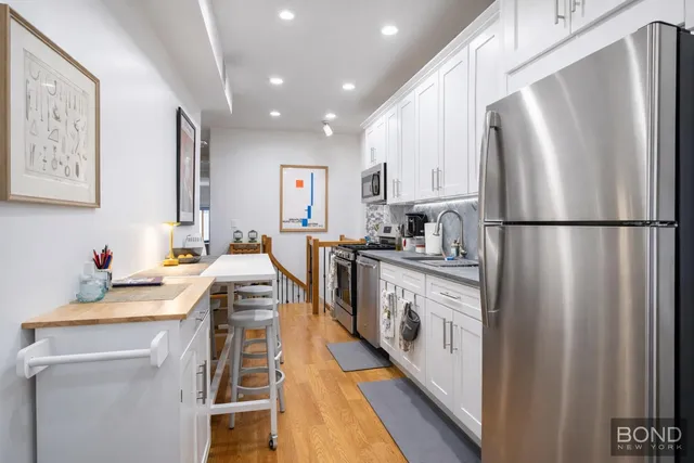 a kitchen with white cabinets and white appliances