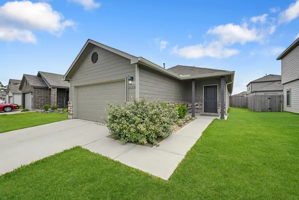 a front view of house with yard and green space
