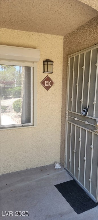 View of exterior entry with stucco siding