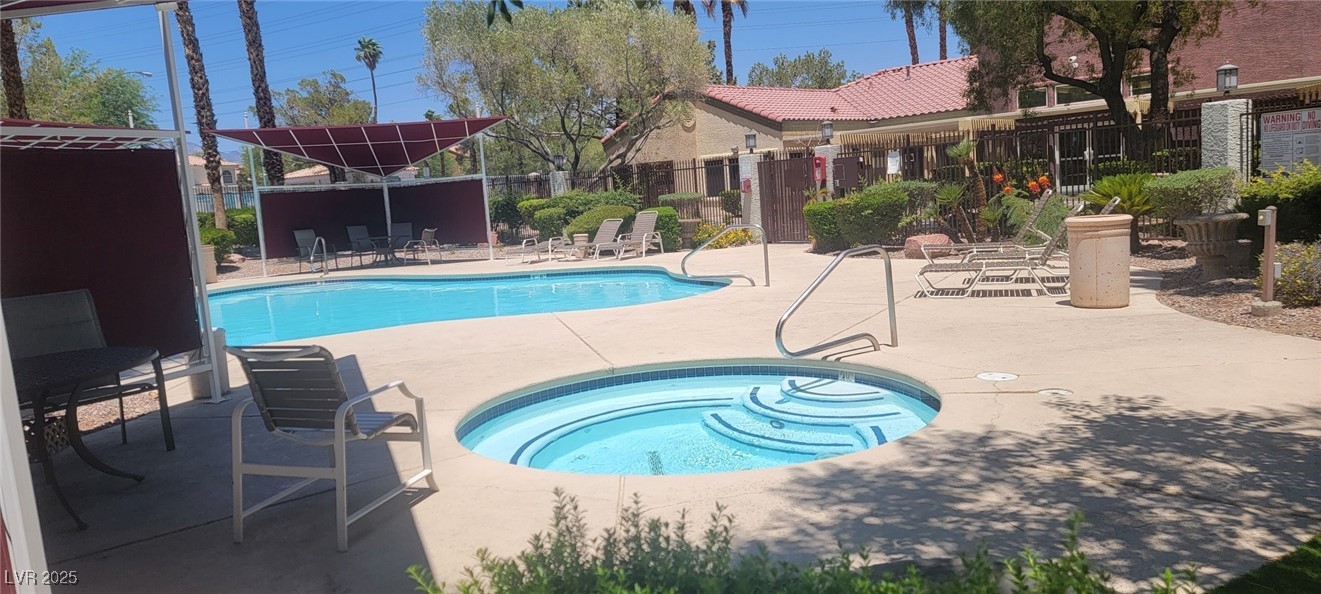 7885 West Flamingo Road, Unit 1010 Las Vegas, NV 89147 - Photo 5 of 32 Community pool featuring a hot tub and a patio