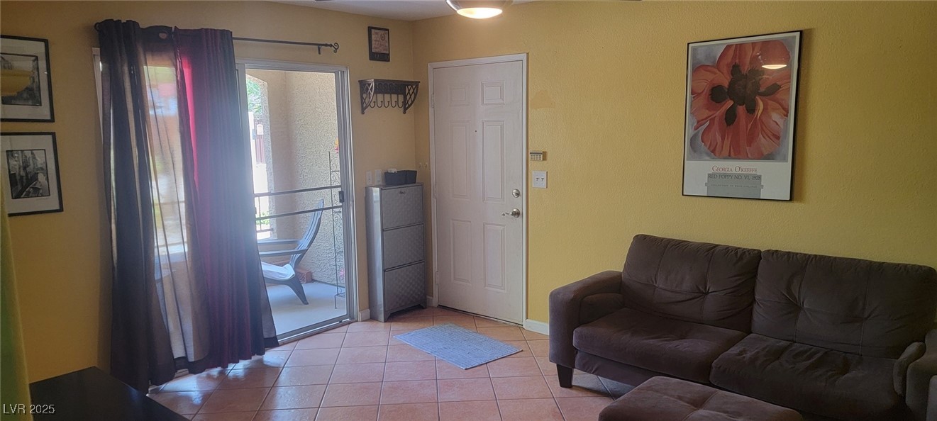 7885 West Flamingo Road, Unit 1010 Las Vegas, NV 89147 - Photo 7 of 32 Living room featuring light tile patterned floorin