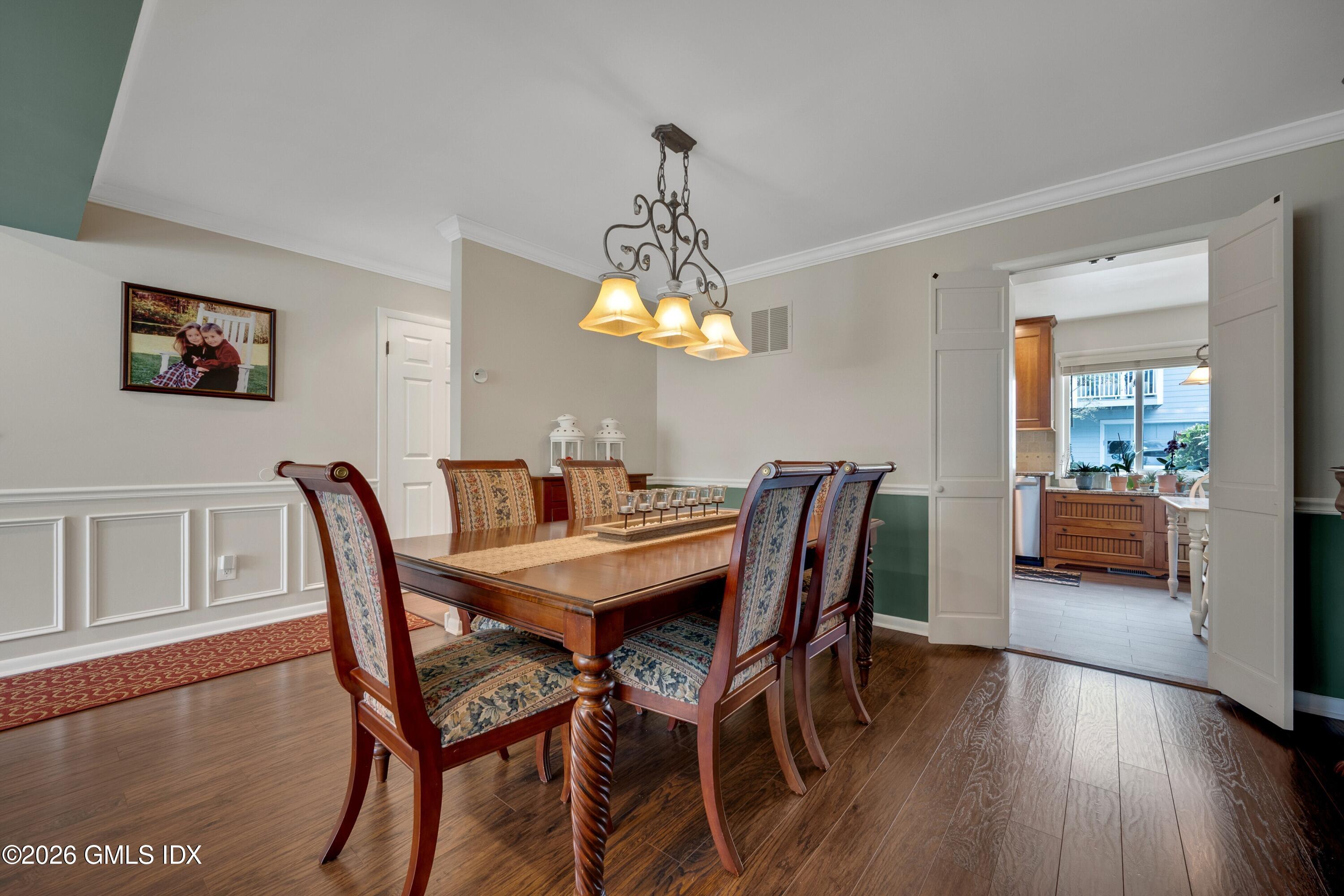 58 Stirrup Lane, Unit 58 Riverside, CT 06878 - Photo 5 of 23 a view of a dining room with furniture and wooden floor