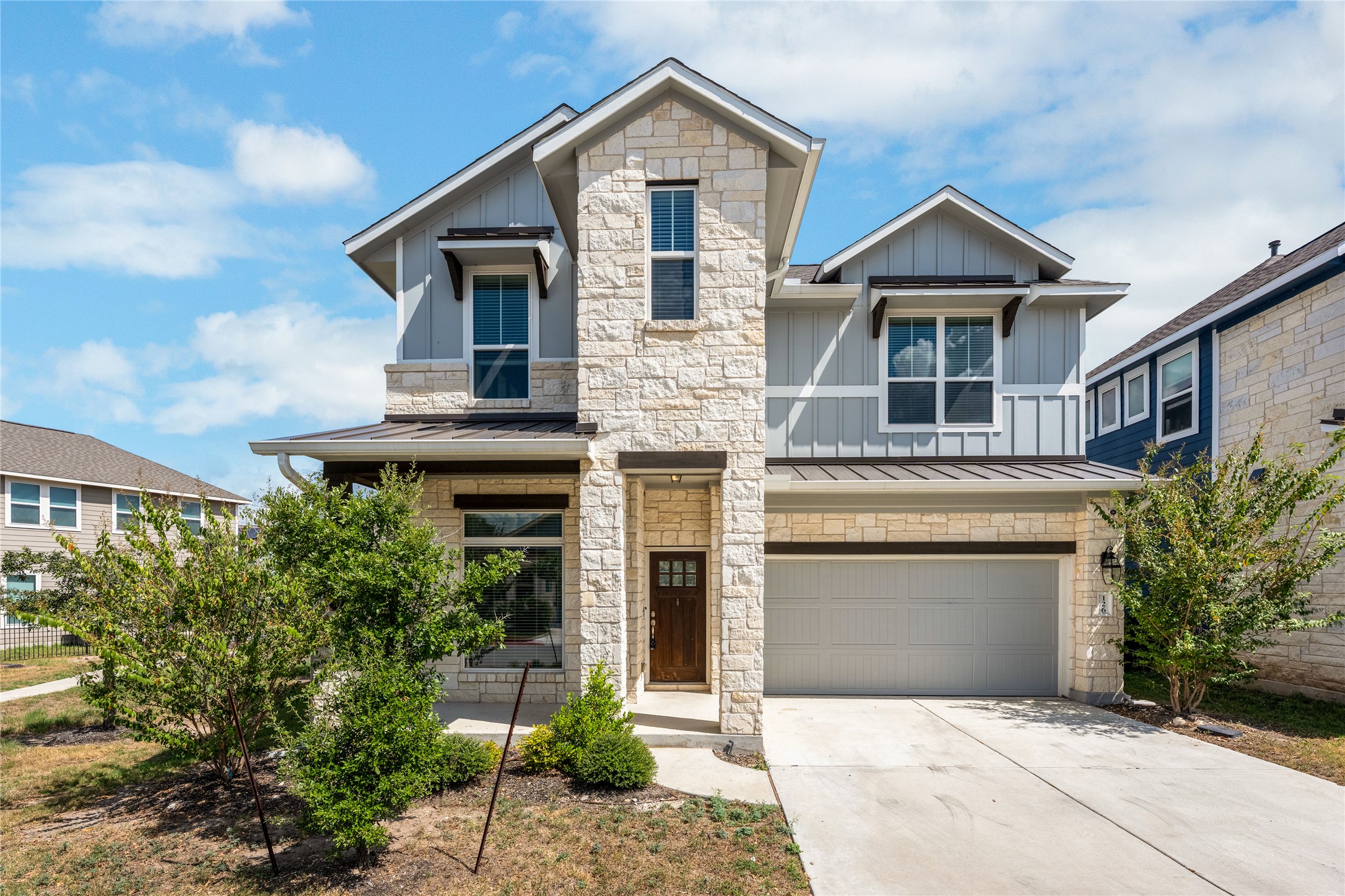 126 Rains Kyle, TX 78640 - Photo 2 of 22 Limestone masonry and vertical siding elements create an inviting contemporary exterior profile.