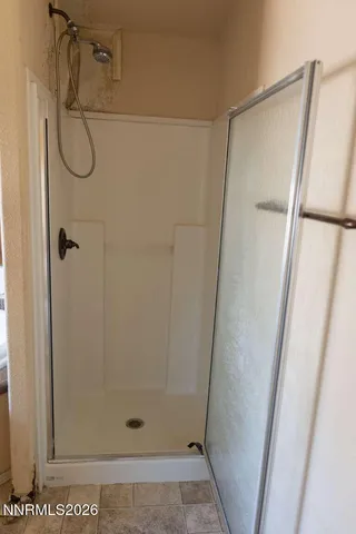 a bathroom with a glass shower door