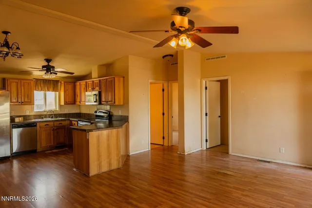 a kitchen with stainless steel appliances granite countertop a stove and a refrigerator