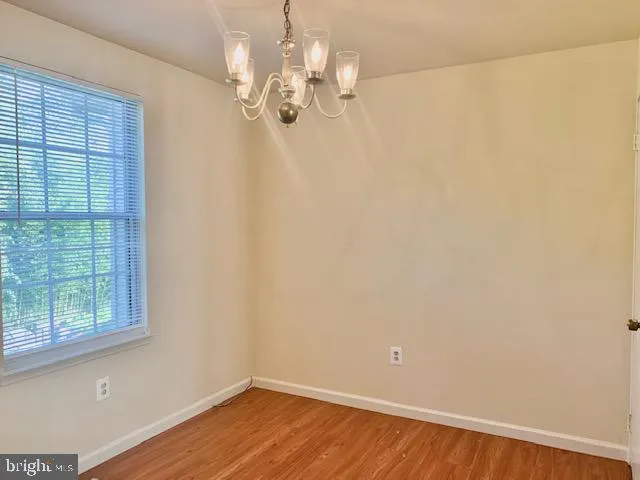 a view of a room with wooden floor and windows