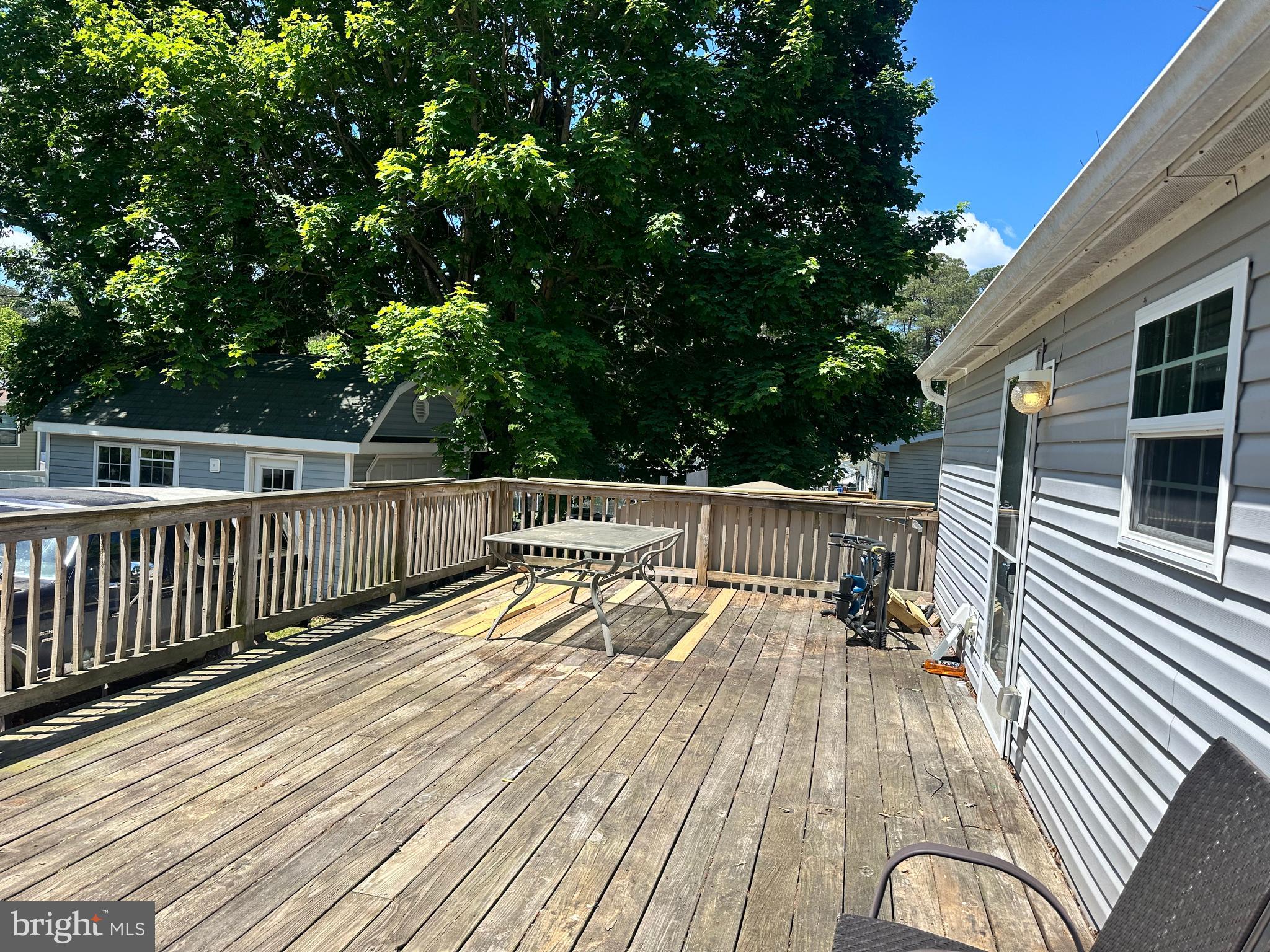 35390 Heron Road Millsboro, DE 19966 - Photo 22 of 25 a view of balcony with wooden floor and outdoor seating