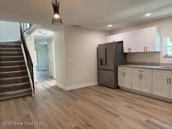 a kitchen with stainless steel appliances granite countertop a refrigerator and a sink
