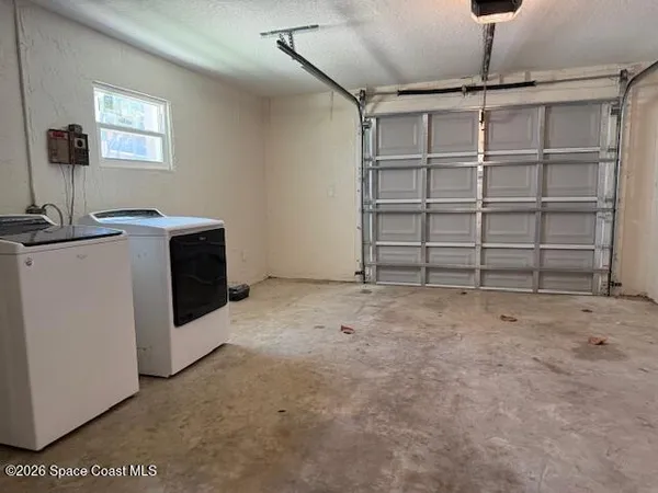 a view of an empty room with a cabinet