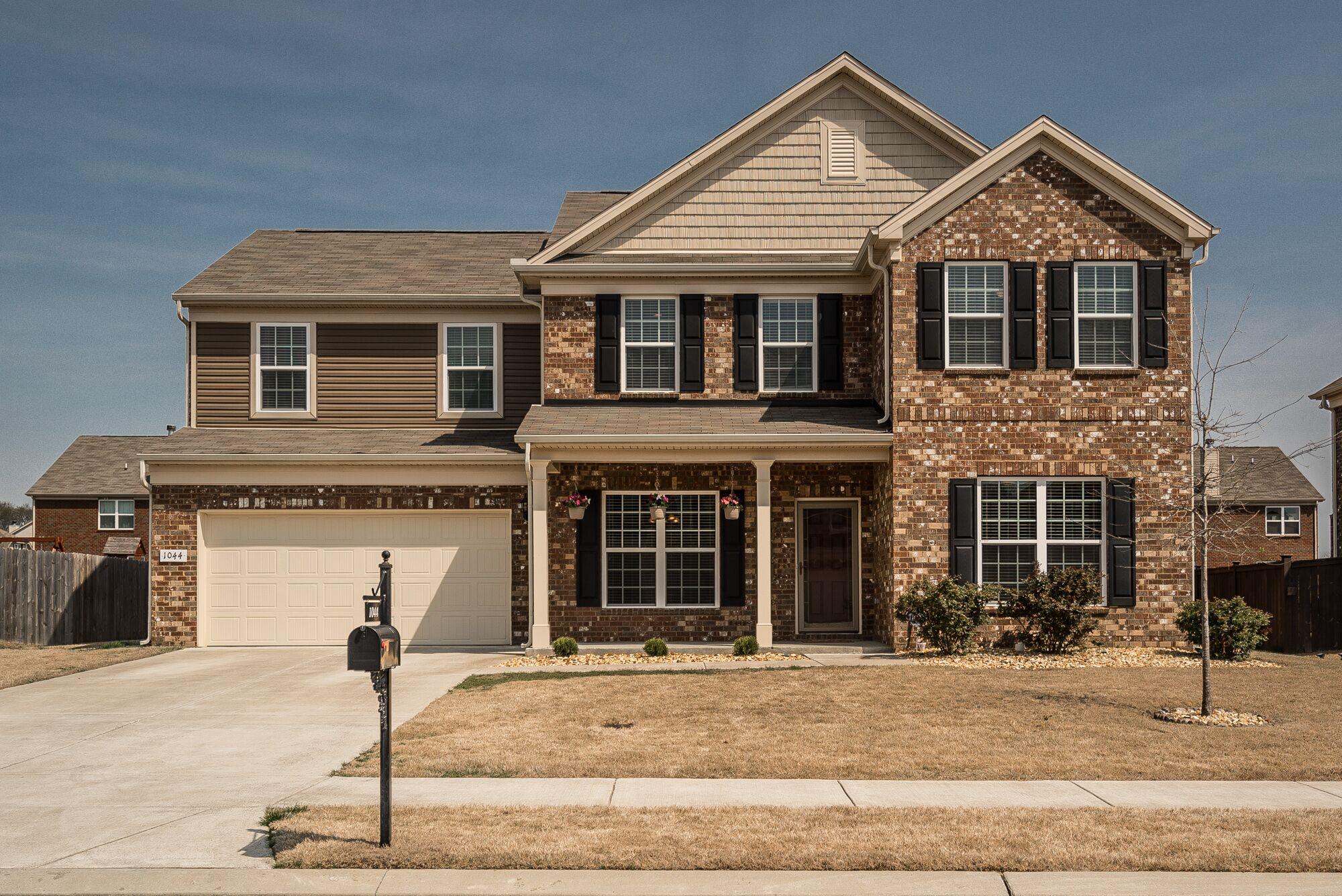 1044 Merrick Road Hendersonville, TN 37075 - Photo 1 of 27 a front view of a house with garage