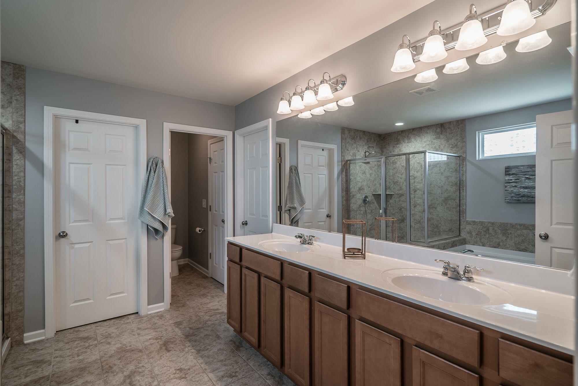 1044 Merrick Road Hendersonville, TN 37075 - Photo 17 of 27 a bathroom with double vanity sink and a mirror