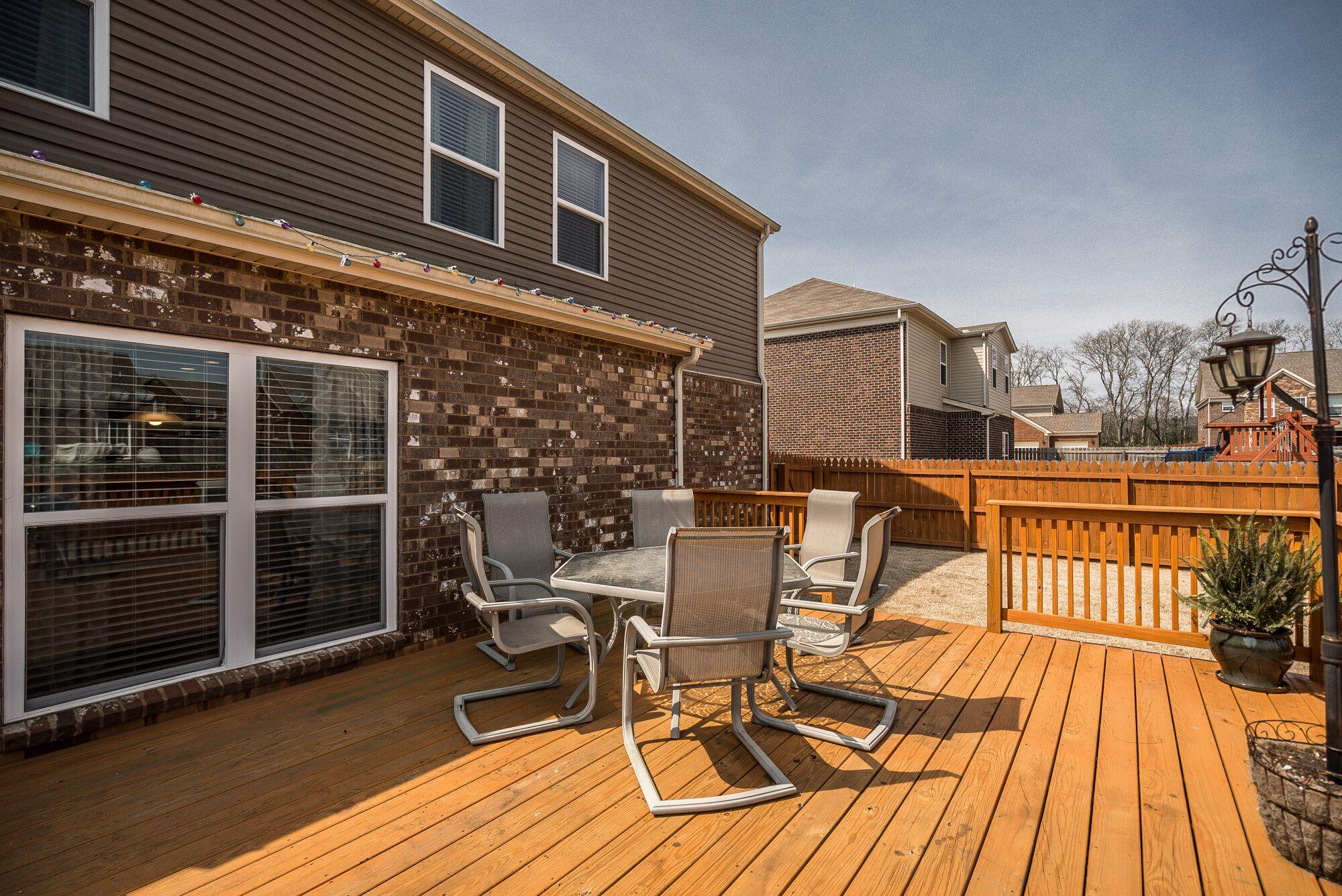 1044 Merrick Road Hendersonville, TN 37075 - Photo 22 of 27 a view of a patio with table and chairs with wooden floor and fence