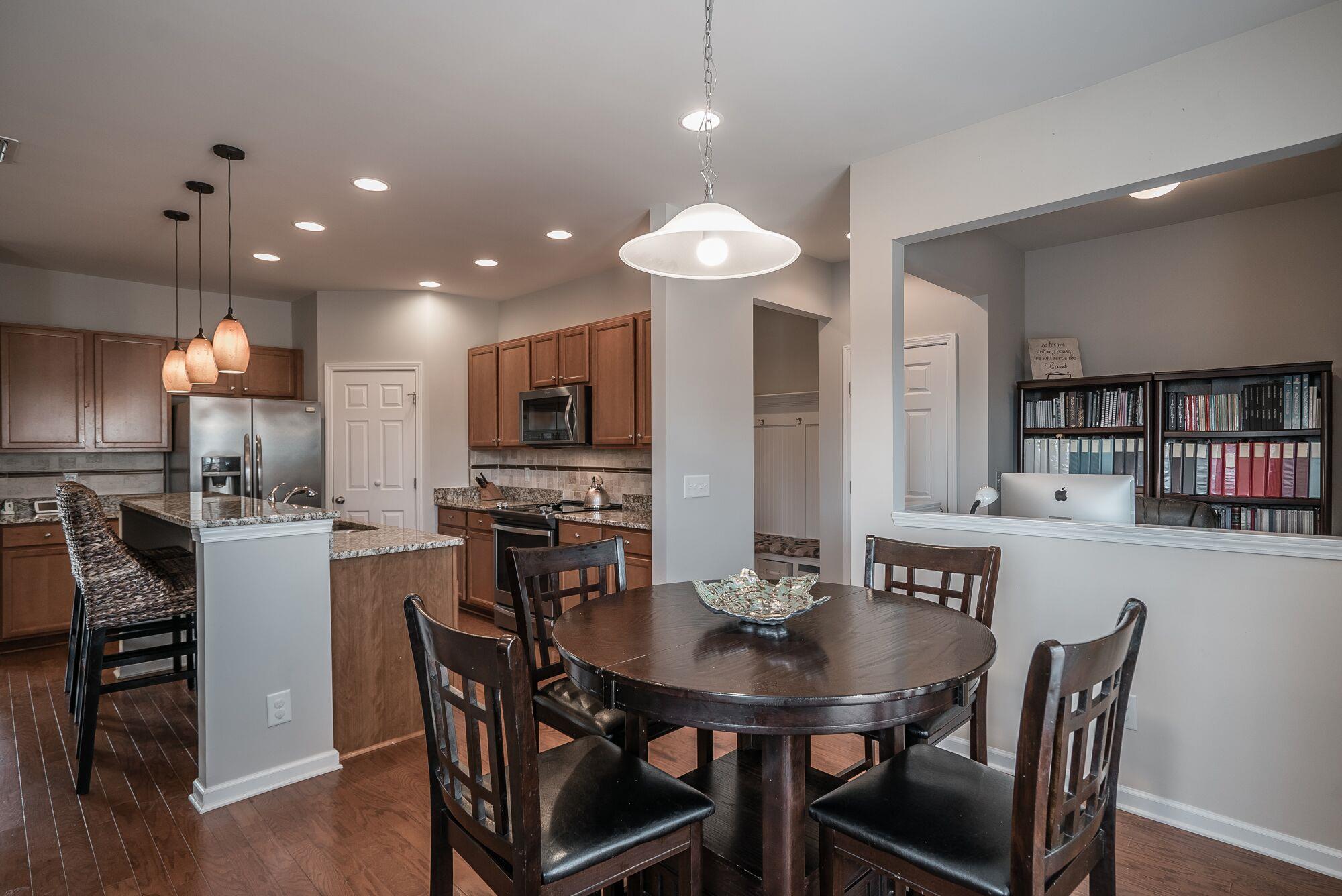 1044 Merrick Road Hendersonville, TN 37075 - Photo 6 of 27 a kitchen with stainless steel appliances kitchen island granite countertop a dining table chairs and refrigerator