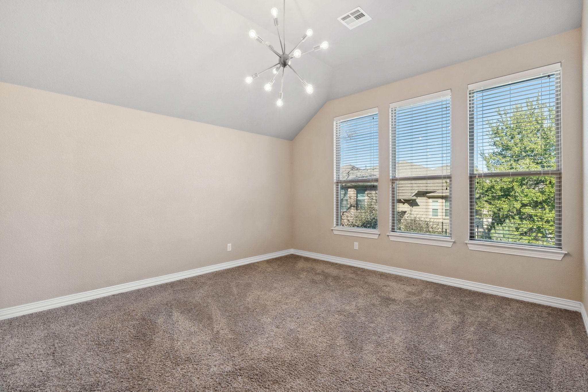3929 Goodnight Trail Leander, TX 78641 - Photo 11 of 29 an empty room with windows and chandelier fan