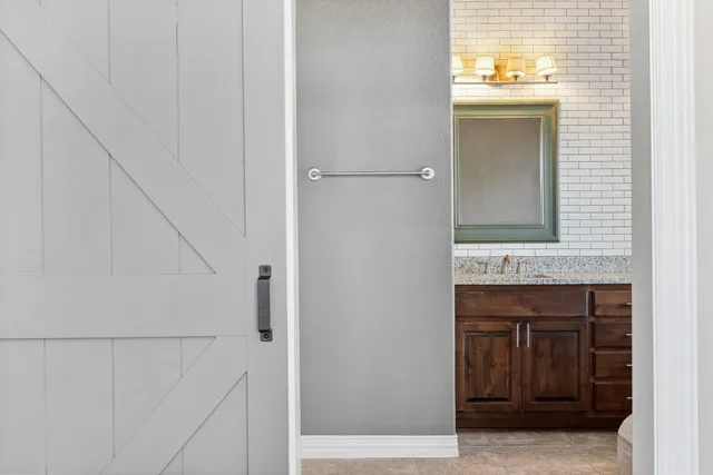 a bathroom with a tub sink and mirror