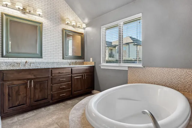 a bathroom with a bathtub and shower