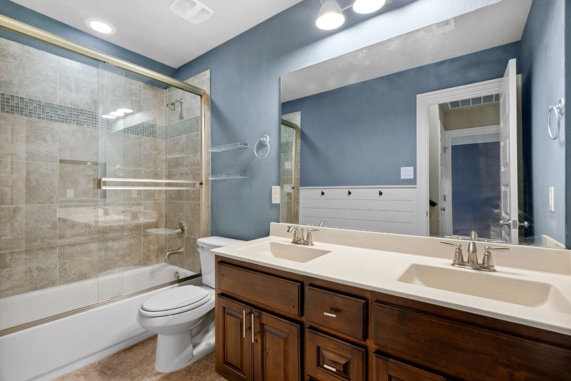 3929 Goodnight Trail Leander, TX 78641 - Photo 21 of 29 a bathroom with a double vanity sink toilet and shower