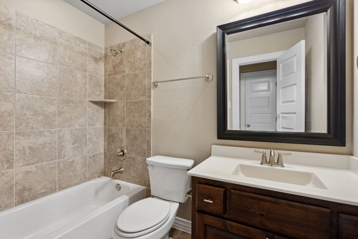 3929 Goodnight Trail Leander, TX 78641 - Photo 24 of 29 a bathroom with a sink and a mirror