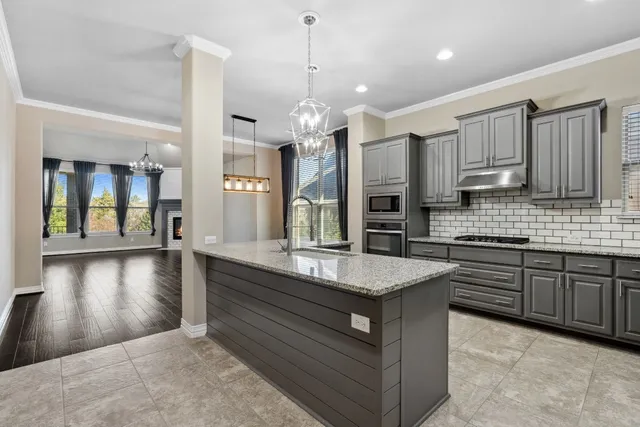 a view of a room with wooden floor fireplace and windows