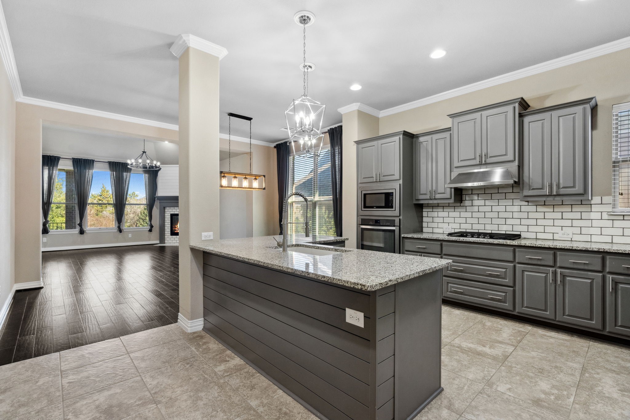 3929 Goodnight Trail Leander, TX 78641 - Photo 3 of 29 a large kitchen with kitchen island a sink stainless steel appliances and cabinets
