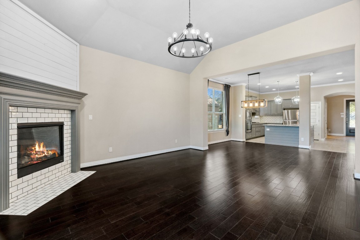 3929 Goodnight Trail Leander, TX 78641 - Photo 6 of 29 a view of an empty room with wooden floor fireplace and a window