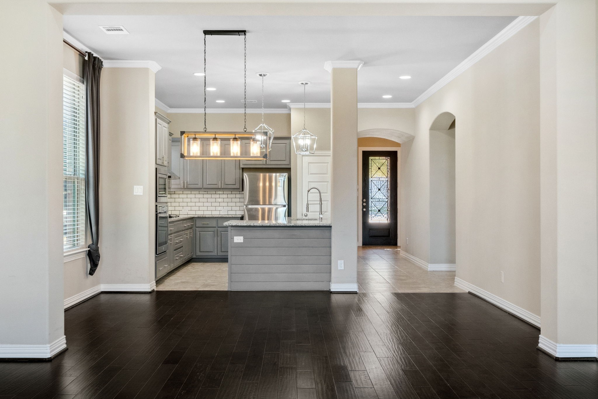 3929 Goodnight Trail Leander, TX 78641 - Photo 7 of 29 a view of a hallway with wooden floor and a kitchen