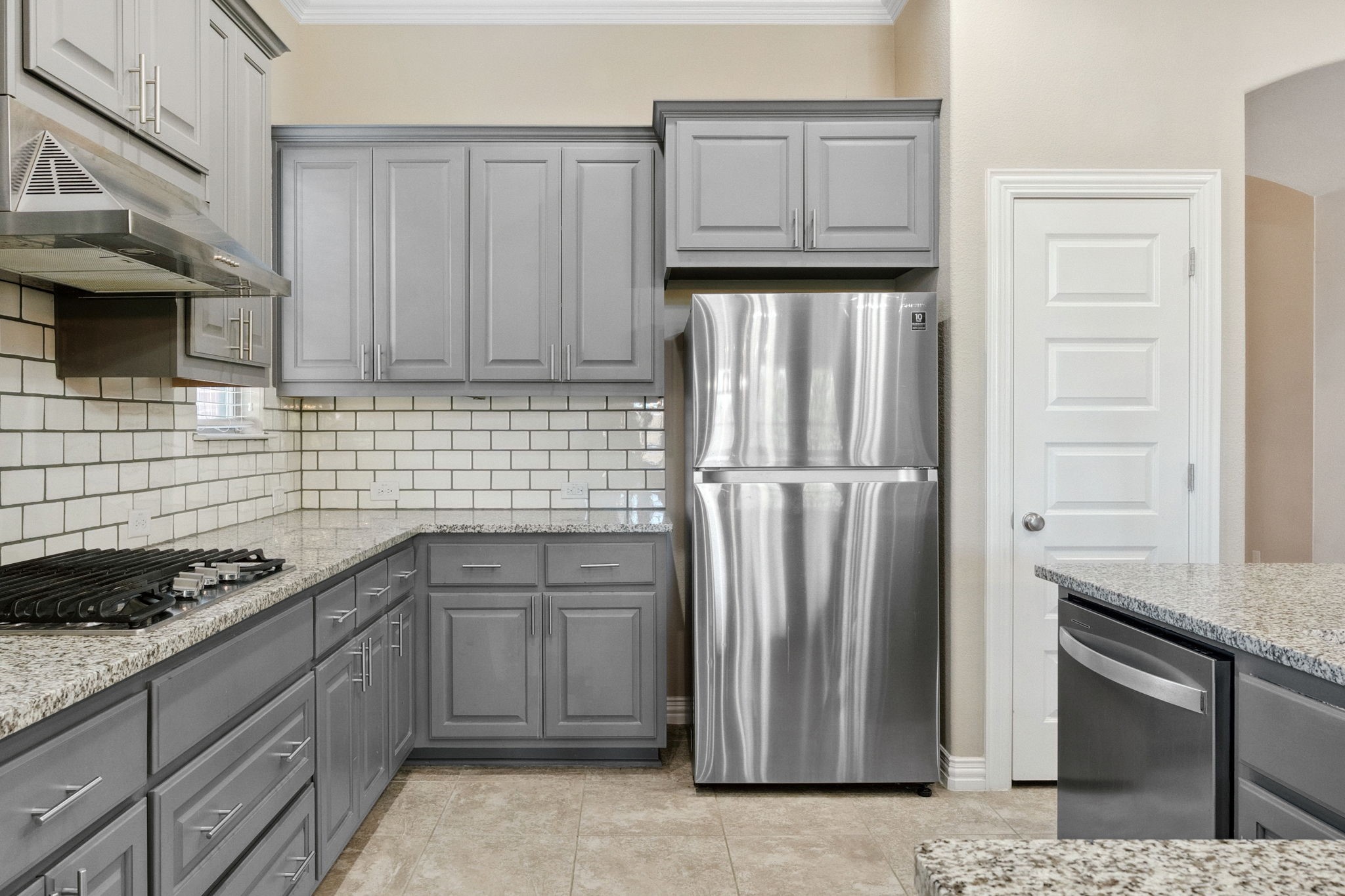 3929 Goodnight Trail Leander, TX 78641 - Photo 9 of 29 a kitchen with granite countertop a refrigerator sink and cabinets