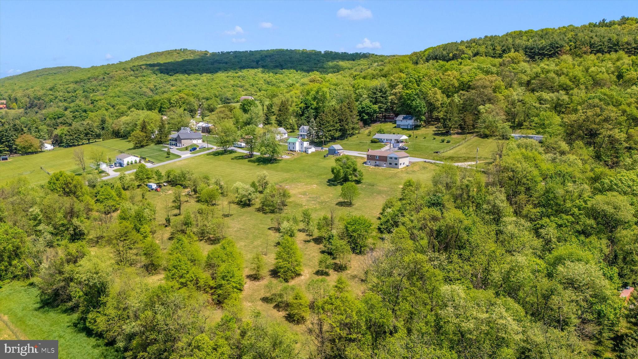 56 Clevelandtown-netz Road Boonsboro, MD 21713 - Photo 3 of 20 a view of a city with lush green forest