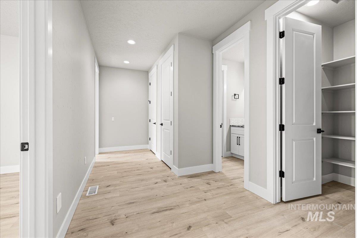 23735 Legends Lane Caldwell, ID 83607 - Photo 20 of 34 Hall with a textured ceiling, light wood-style flooring, and recessed lighting