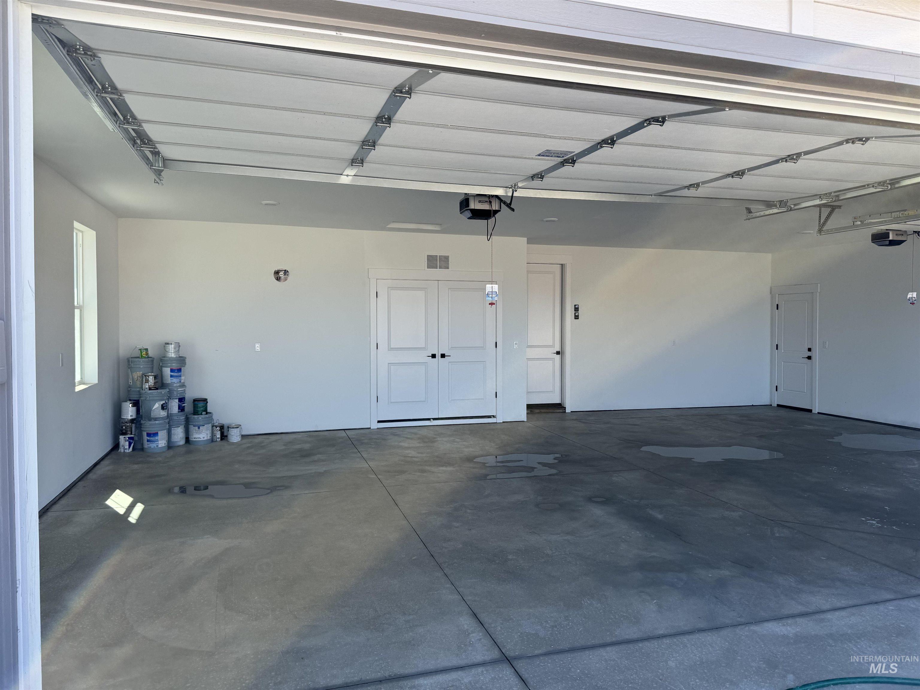 23735 Legends Lane Caldwell, ID 83607 - Photo 5 of 34 Garage featuring a garage door opener
