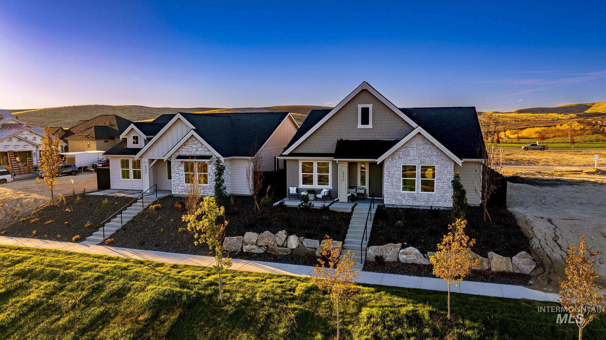 6370 North Barholm Lane Eagle, ID 83616 - Photo 2 of 33 View of front of house with stairway, stone siding, a porch, and board and batten siding