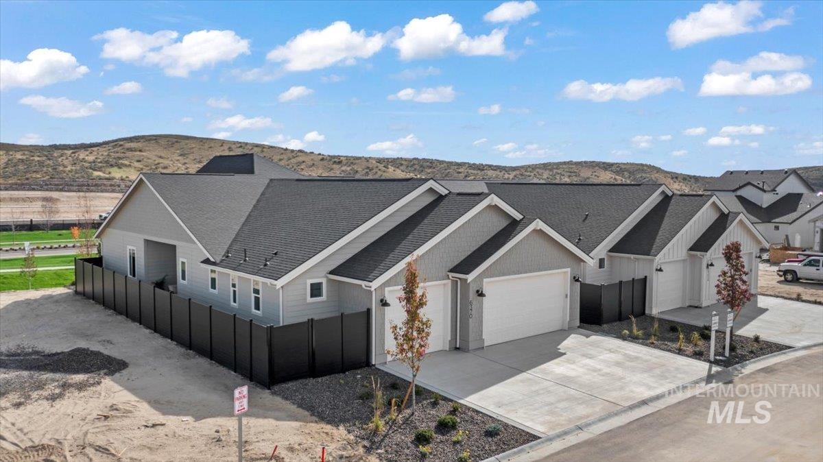 6370 North Barholm Lane Eagle, ID 83616 - Photo 22 of 33 Aerial view of property and surrounding area featuring a mountain backdrop