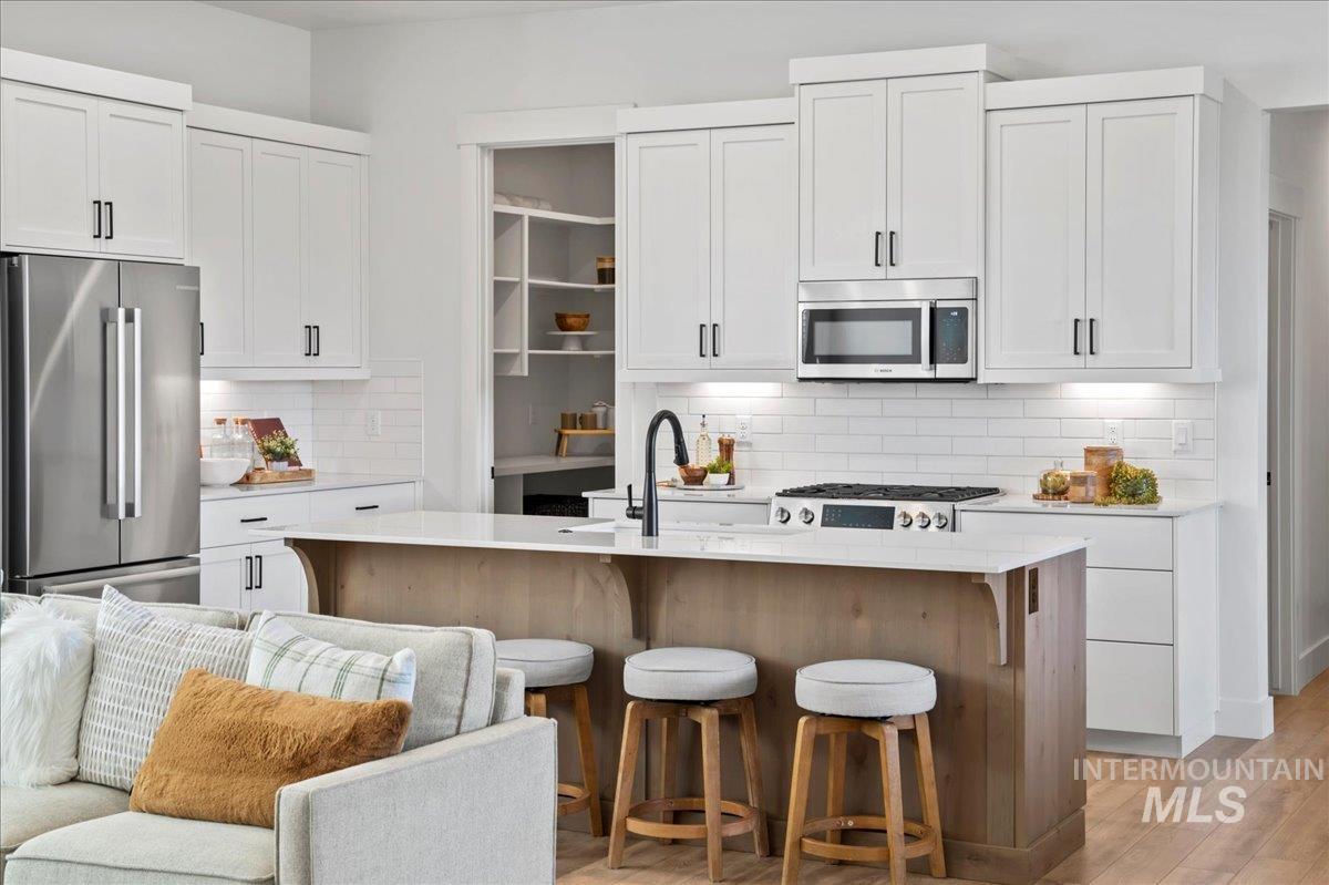 6370 North Barholm Lane Eagle, ID 83616 - Photo 10 of 33 Kitchen featuring stainless steel appliances and white cabinetry