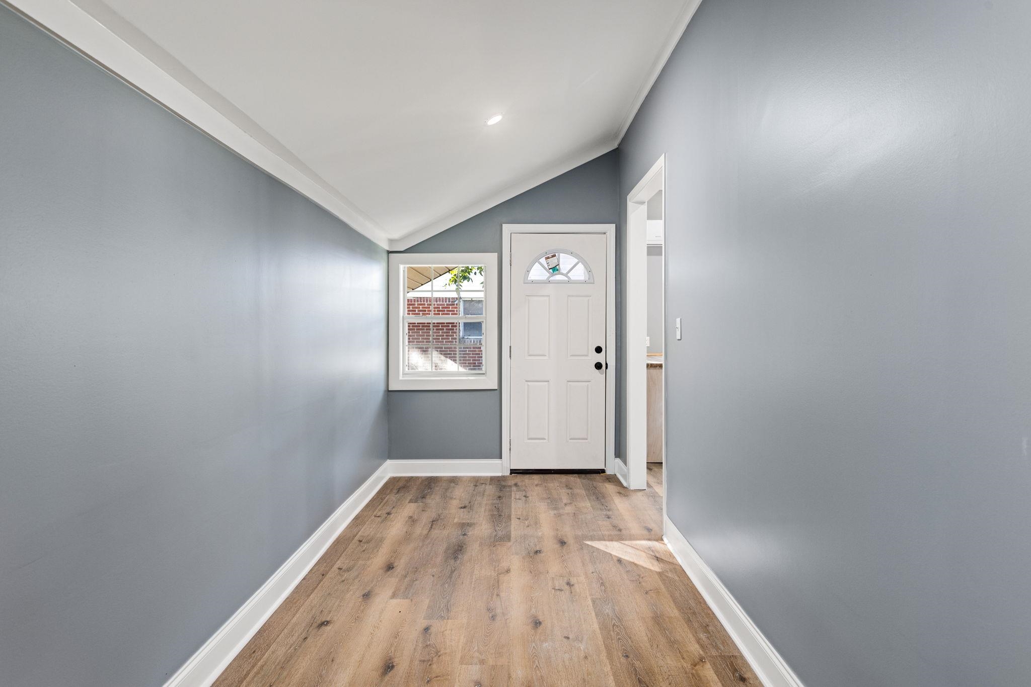 1218 Proper Street Corinth, MS 38834 - Photo 12 of 14 a view of a hallway with wooden floor and a bathroom