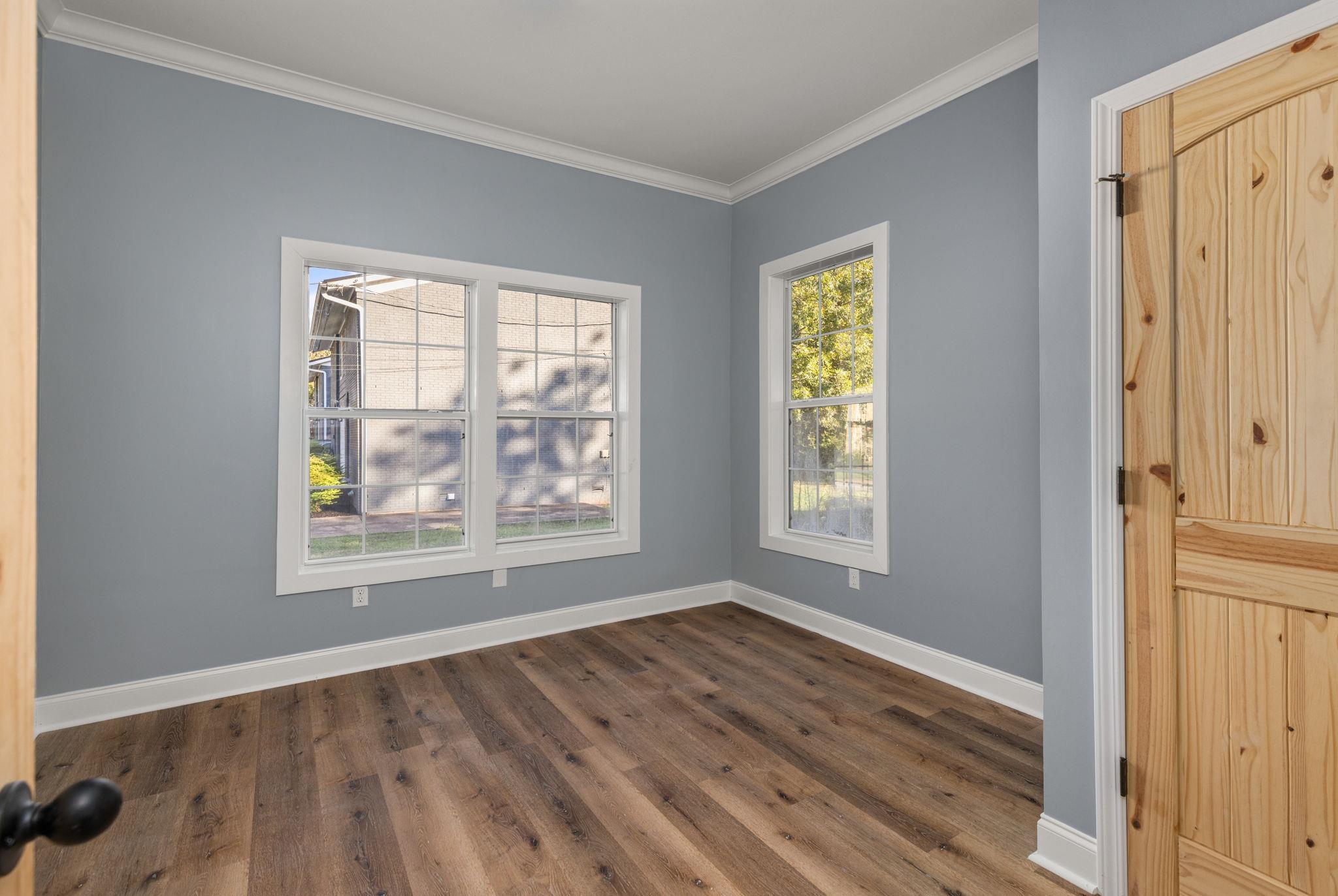 1218 Proper Street Corinth, MS 38834 - Photo 3 of 14 a view of an empty room with wooden floor and a window