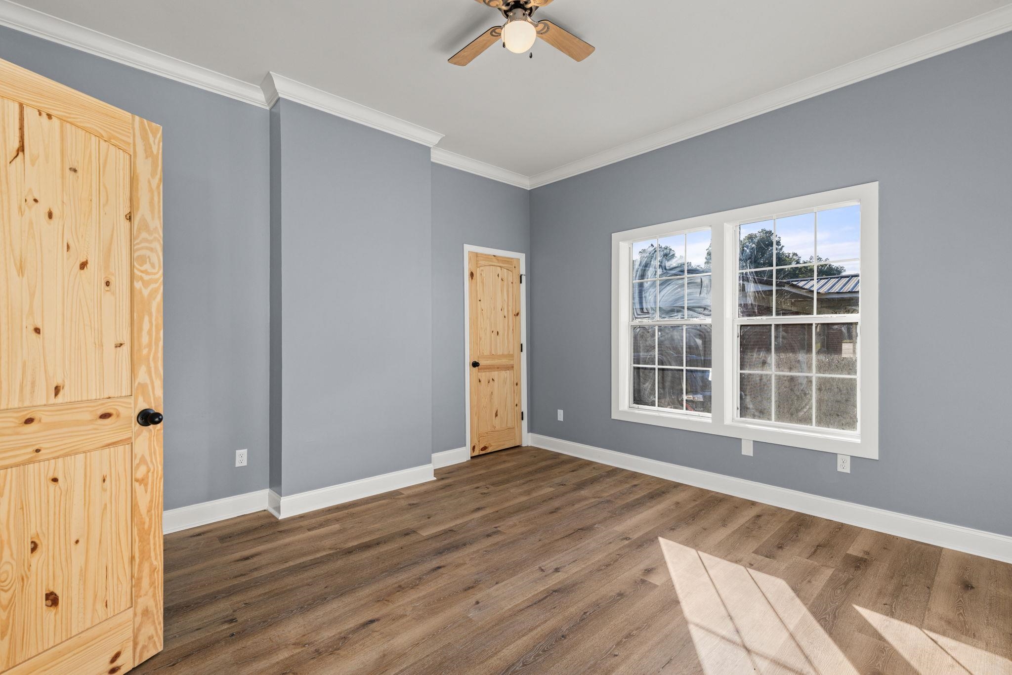 1218 Proper Street Corinth, MS 38834 - Photo 5 of 14 an empty room with wooden floor and windows