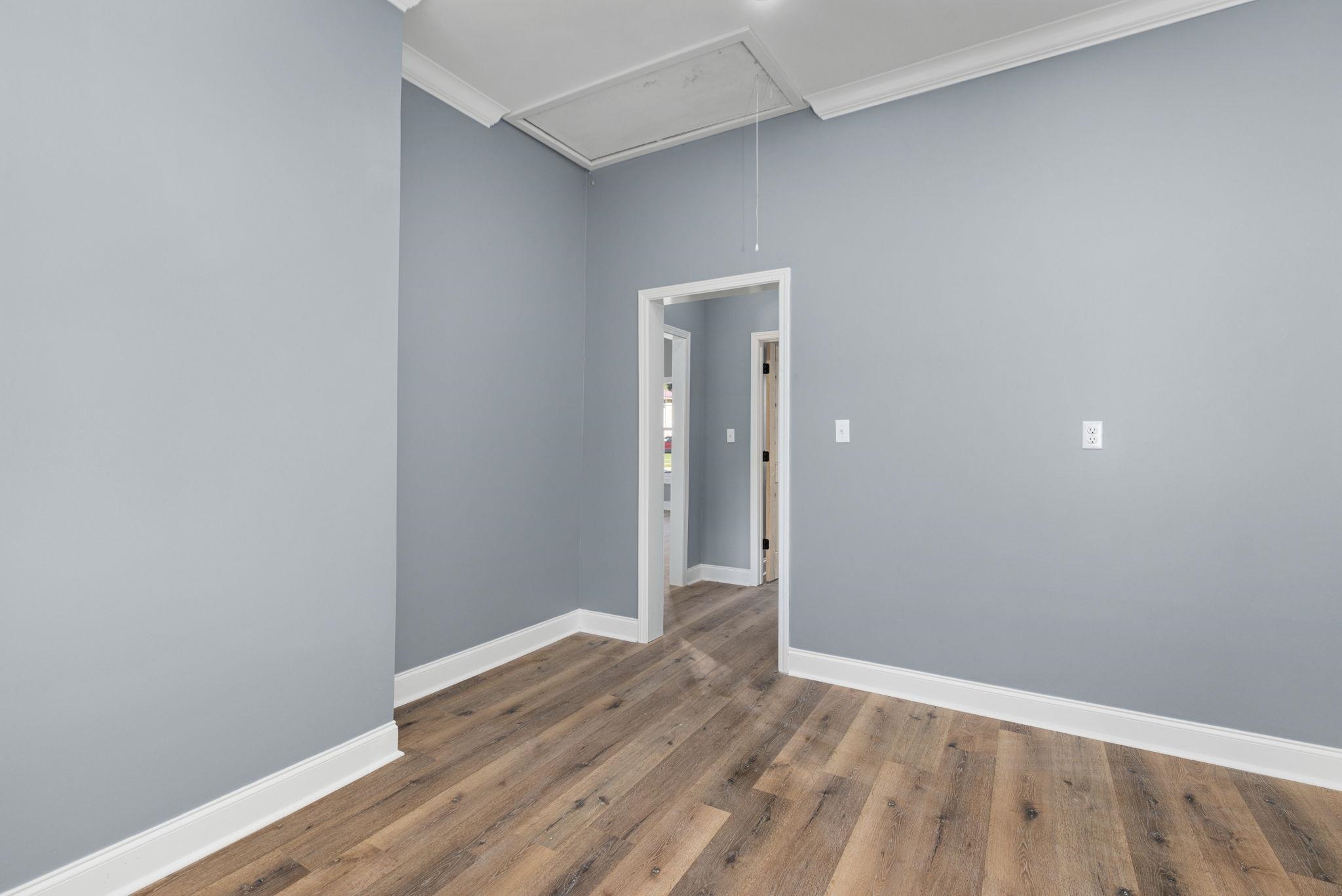 1218 Proper Street Corinth, MS 38834 - Photo 10 of 14 a view of an empty room with wooden floor and a window