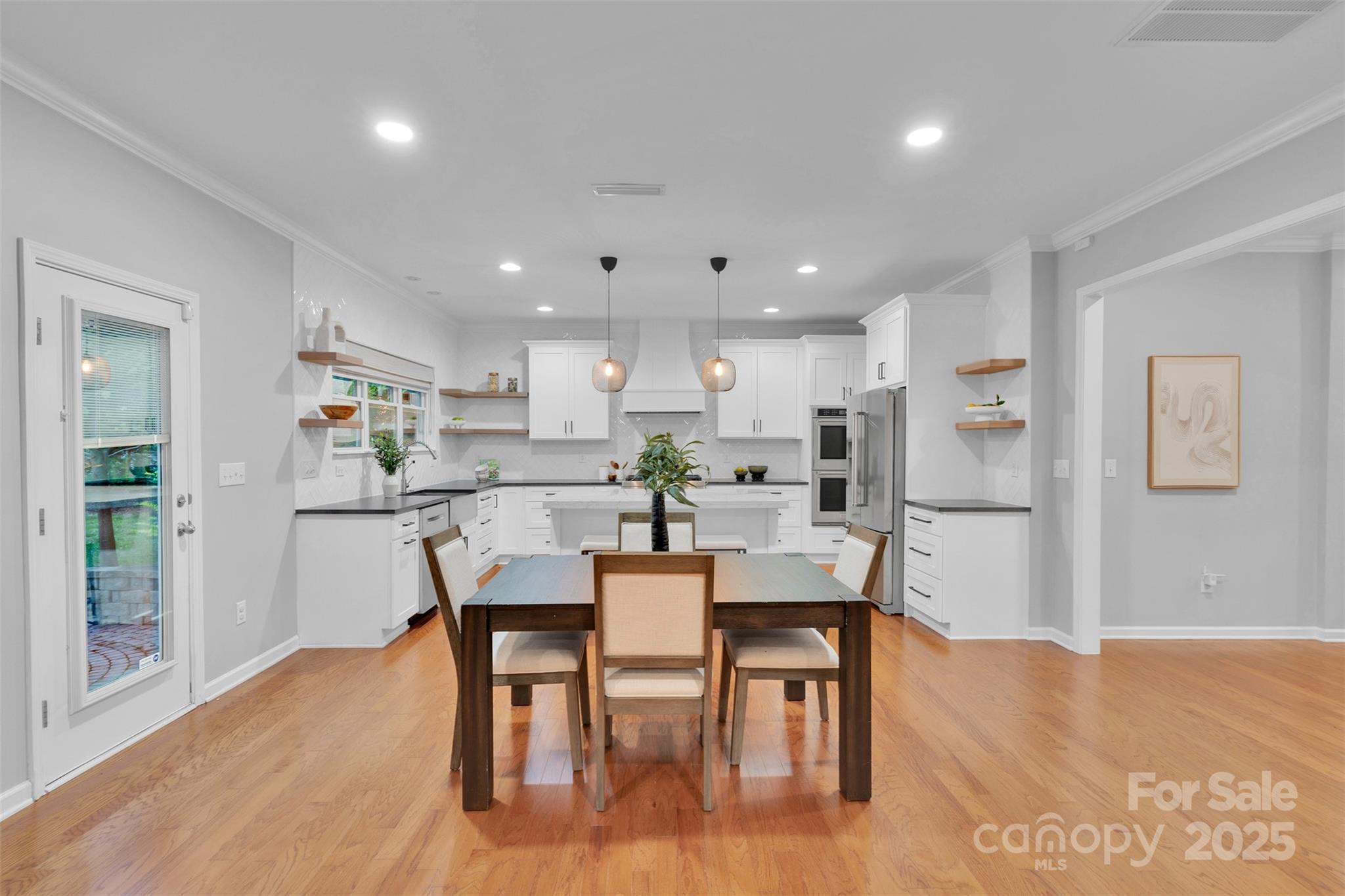 226 Bubbling Well Road Matthews, NC 28105 - Photo 13 of 47 a view of a dining room with furniture and wooden floor