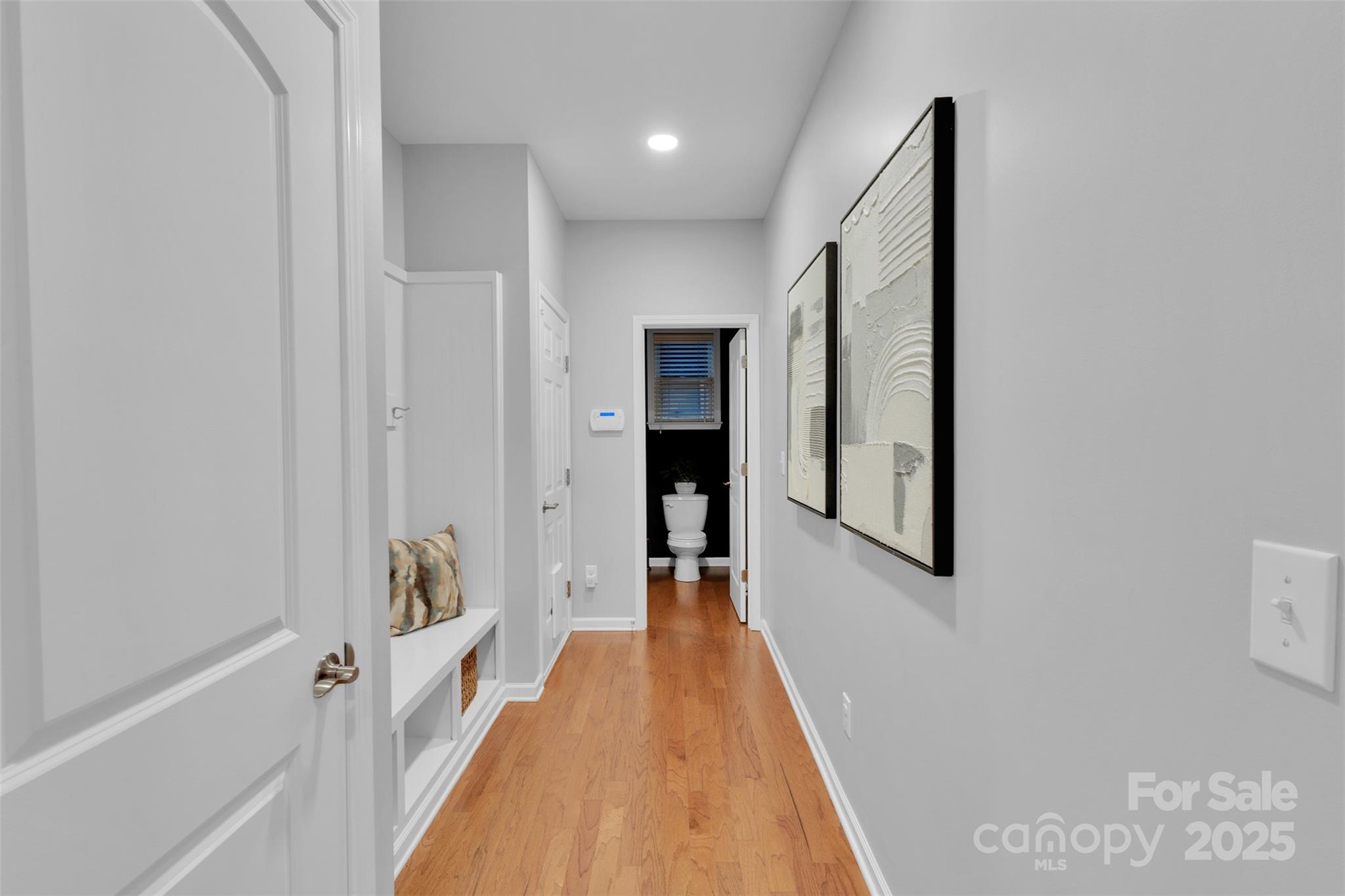 226 Bubbling Well Road Matthews, NC 28105 - Photo 20 of 47 a view of a hallway with wooden floor and staircase
