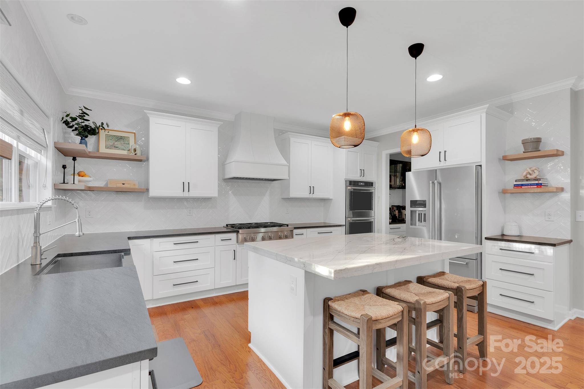 226 Bubbling Well Road Matthews, NC 28105 - Photo 2 of 47 a kitchen with a table and chairs in it