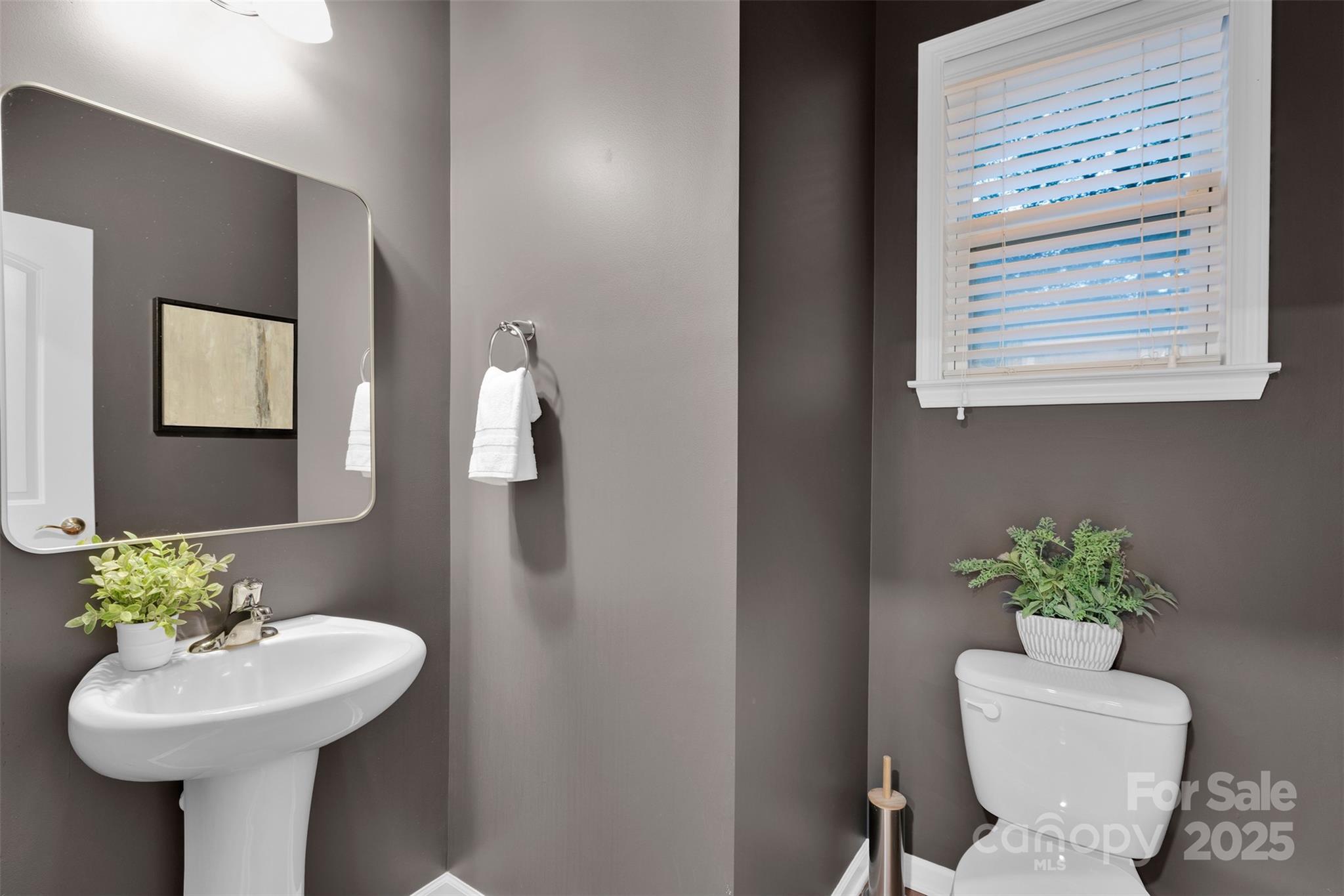 226 Bubbling Well Road Matthews, NC 28105 - Photo 21 of 47 a bathroom with a toilet sink and mirror