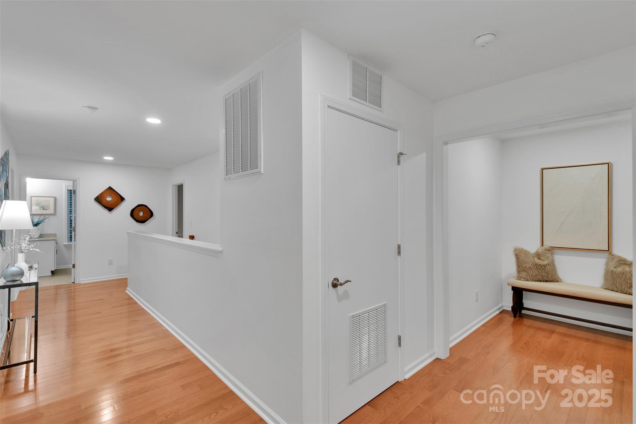 226 Bubbling Well Road Matthews, NC 28105 - Photo 26 of 47 a view of a hallway to a room with wooden floor and staircase