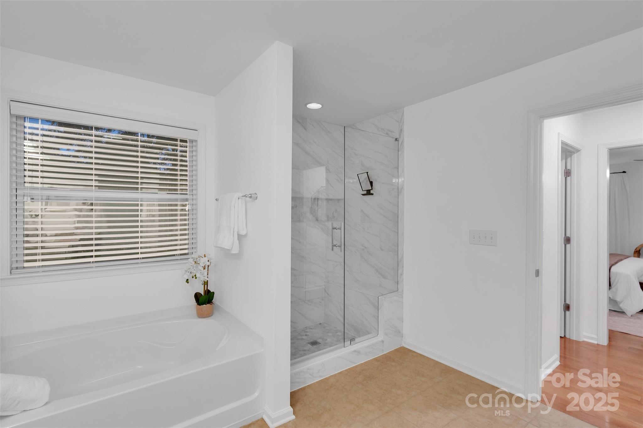 226 Bubbling Well Road Matthews, NC 28105 - Photo 31 of 47 a bathroom with a bathtub and a shower