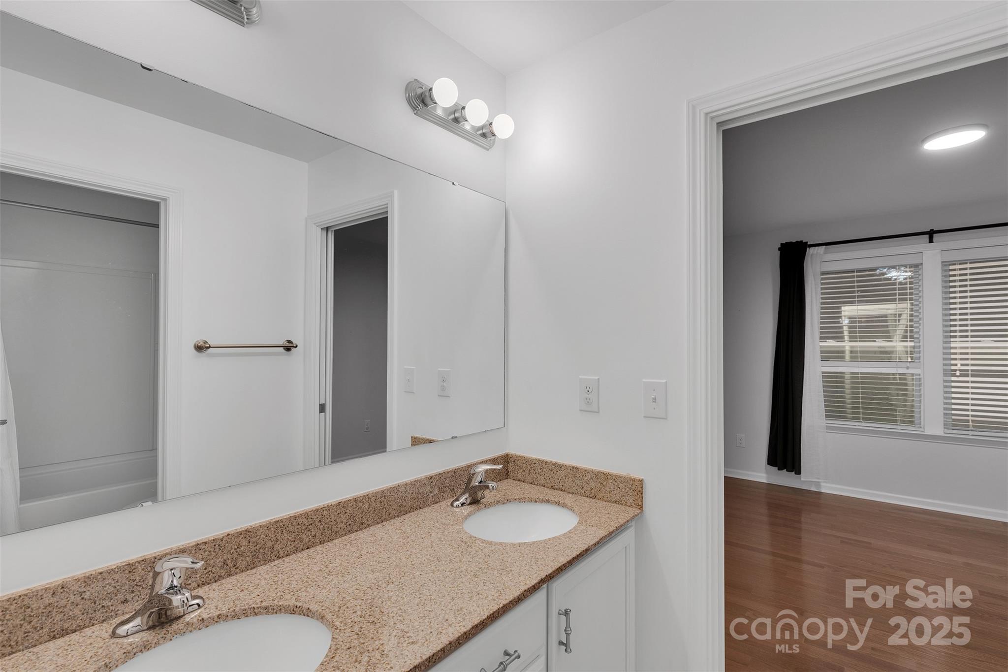 226 Bubbling Well Road Matthews, NC 28105 - Photo 40 of 47 a bathroom with a granite countertop sink and a mirror
