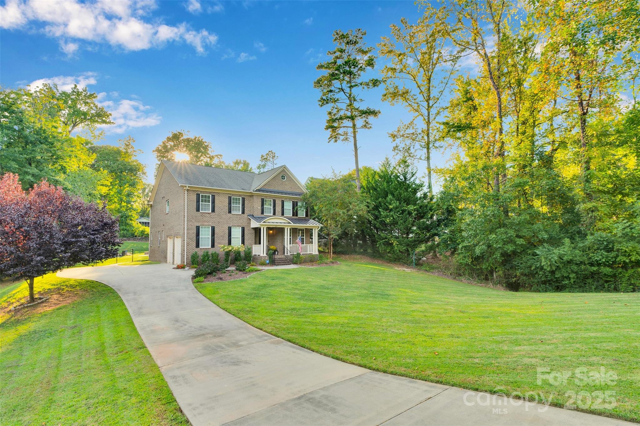 226 Bubbling Well Road Matthews, NC 28105 - Photo 47 of 47 a view of a white house with a big yard and potted plants