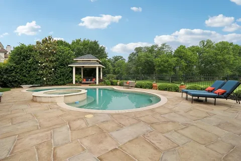 a swimming pool with outdoor seating and yard